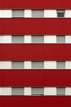 Red color facade and windows of a building.