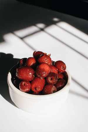 Chinese red date or Jujube asian herbal fruit for healthy on white background under sunlight. The fruit and its seeds are used in Chinese traditional medicine.